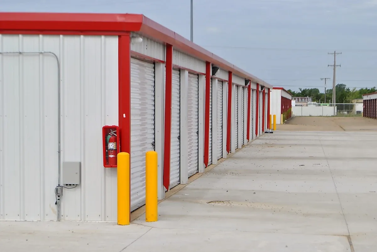 Storage facility with red trim and fire extinguisher on side  
